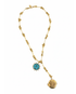 Gold necklace with turquoise pendant and brass engraved starburst locket on a white background