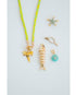 grouping of a gold fish pendant, shark tooth charm, starfish pendant, pave pickleball charm, and round turquoise charm with a neon yellow cord necklace against a light gray background.