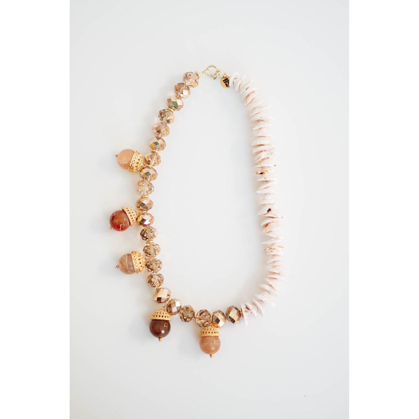 Bracelet with acorn-shaped beads on a white background