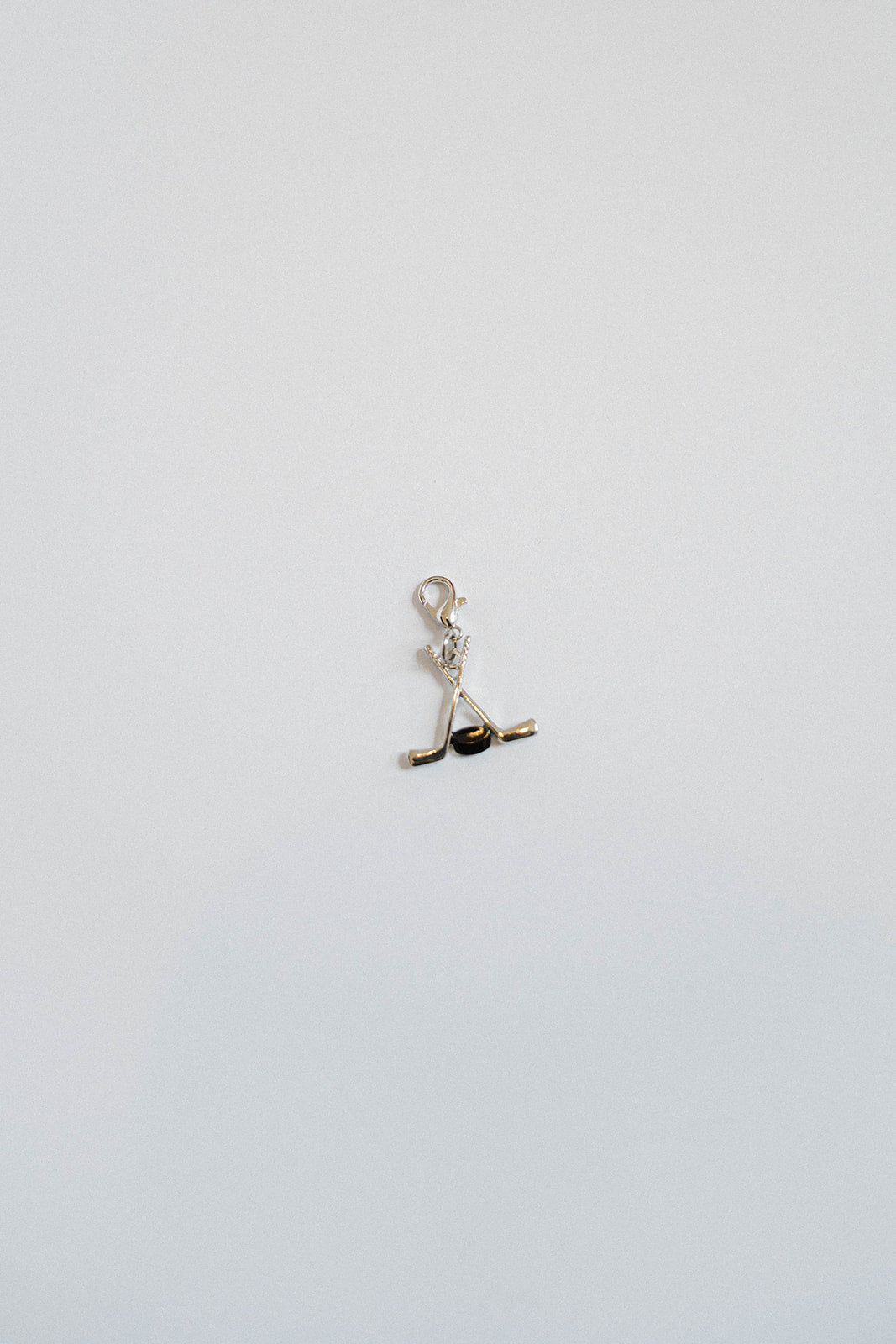 Hockey Sticks & Puck Charm