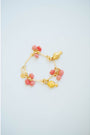 Gold and pink charm bracelet on a light blue background