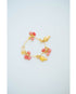 Gold and pink charm bracelet on a light blue background