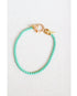 mint green box chain bracelet with a gold pave lever clasp on a light grey background