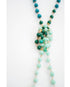 Necklace with green and gold beads on a white background