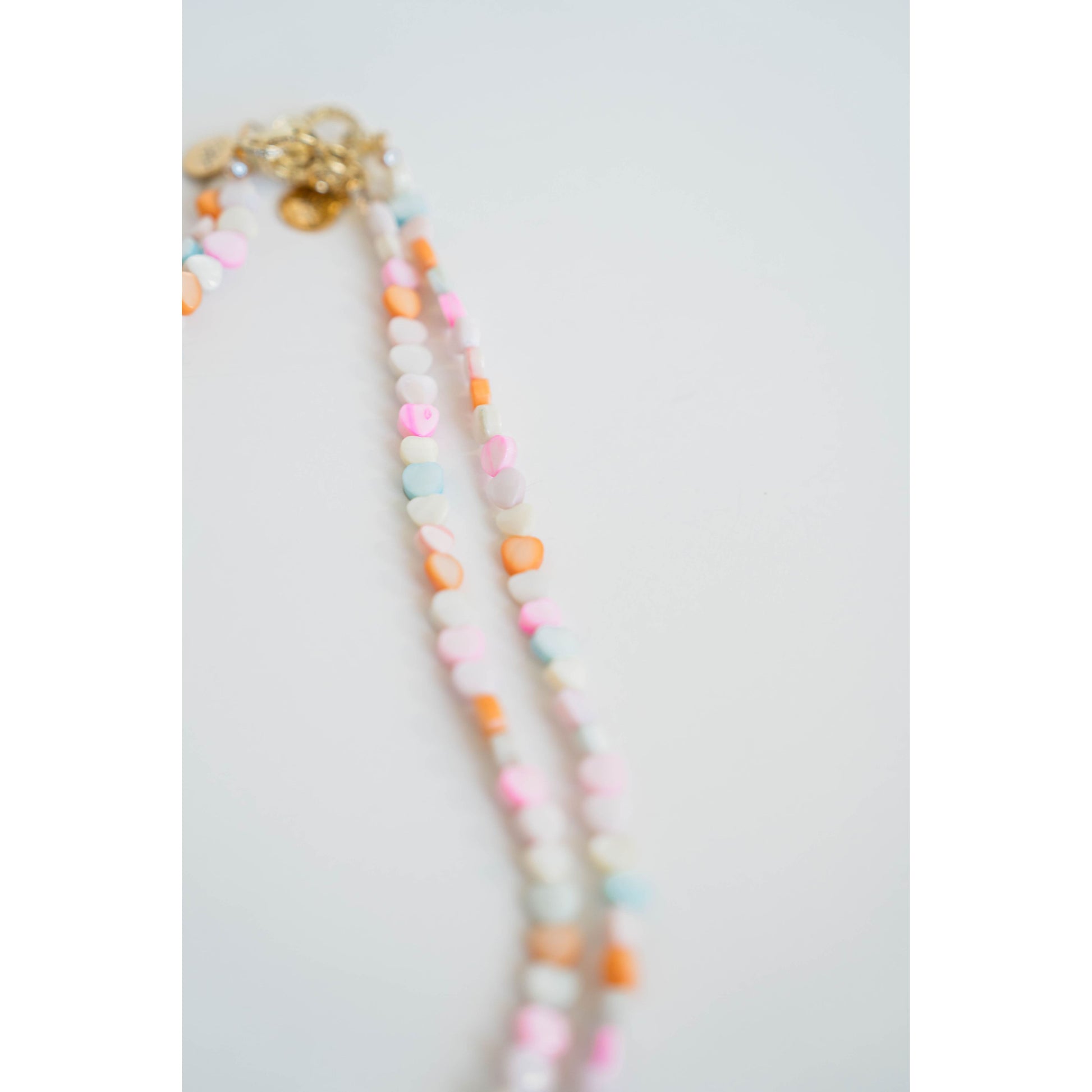 Colorful beaded necklace on a white background