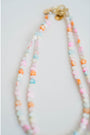 two colorful necklaces of pastel colored heart beads with gold clasps