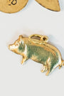gold pig charm on a light background