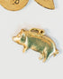gold pig charm on a light background