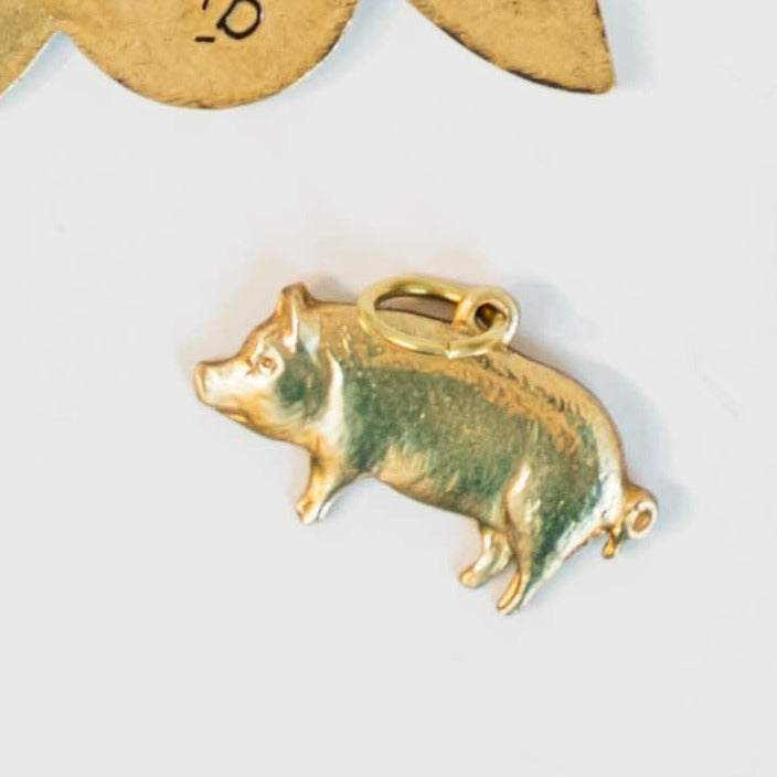 gold pig charm on a light background