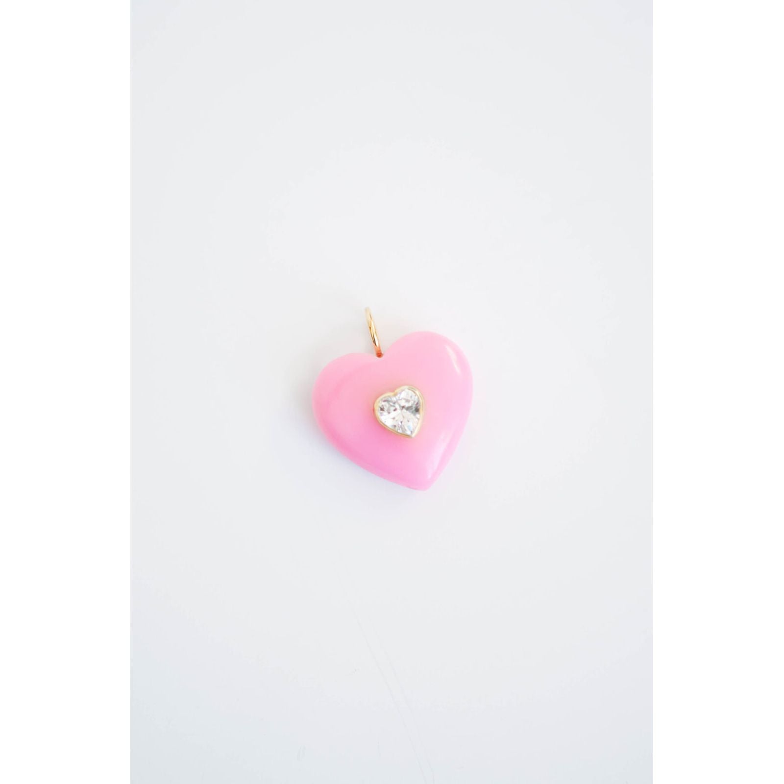 pink heart-shaped pendnat with a small diamond-like center accent on a light background