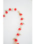 Necklace with red crystal and mint green beads on a white background