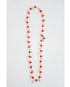 Long necklace with red crystal beads and mint green and gold accents on a light gray background