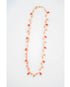 Necklace with orange and peach seashell beads on a white background