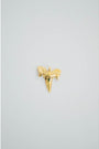 Gold textured shark tooth charm on a light gray background