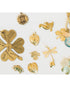 Collection of various gold st patricks day jewlery charms on a white background