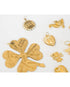 Collection of gold heart and clover charms on a white background