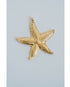 Gold detailed starfish pendant on a light gray background