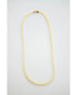 Gold and yellow beaded necklace on a light gray background