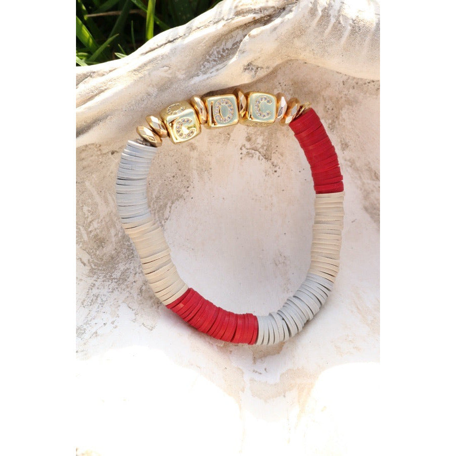 A crimson, tan and grey colorblock polymer clay braclet with gold pave box beads in the letters C O C for College of Charleston fans.